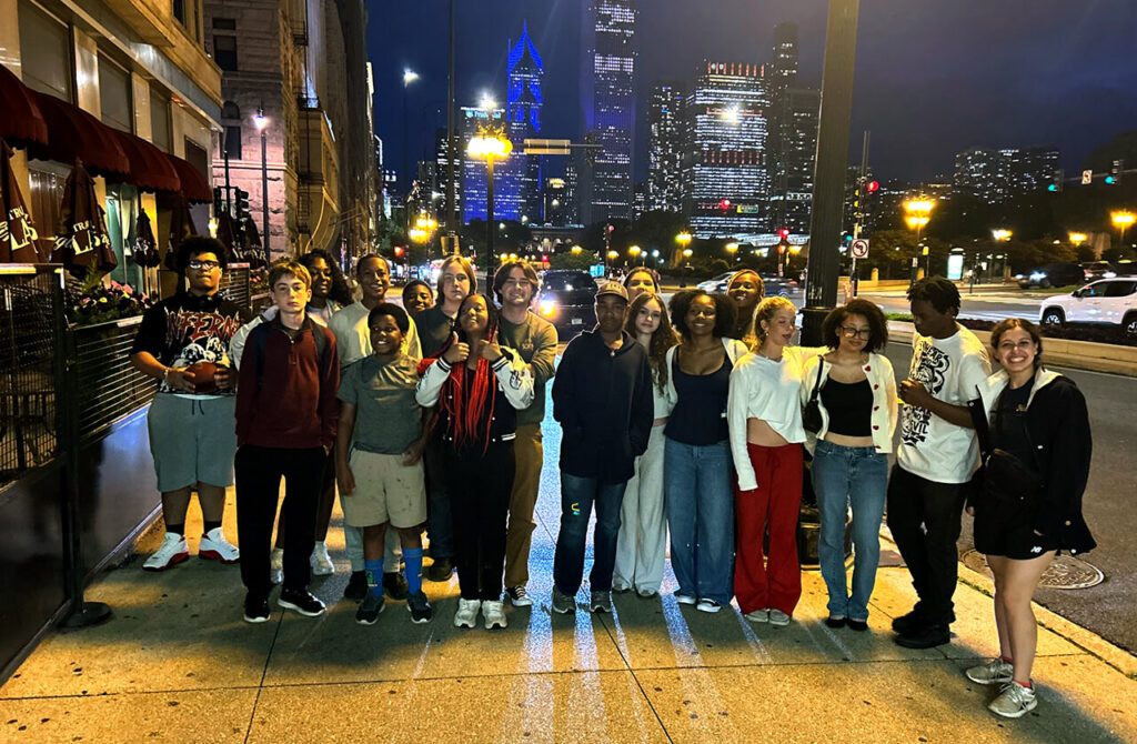 Group photo of Mission St. Louis students in downtown Chicago with evening city scape in background