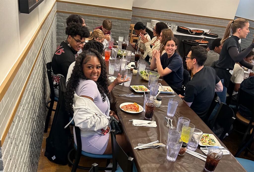 Candid shot of Mission St. Louis students eating out at a restaurant in Chicago